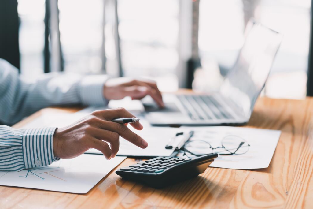 accounting businessman are calculating income expenditure and analyzing real estate investment data dedicated to the progress and growth of the company financial and tax systems concept